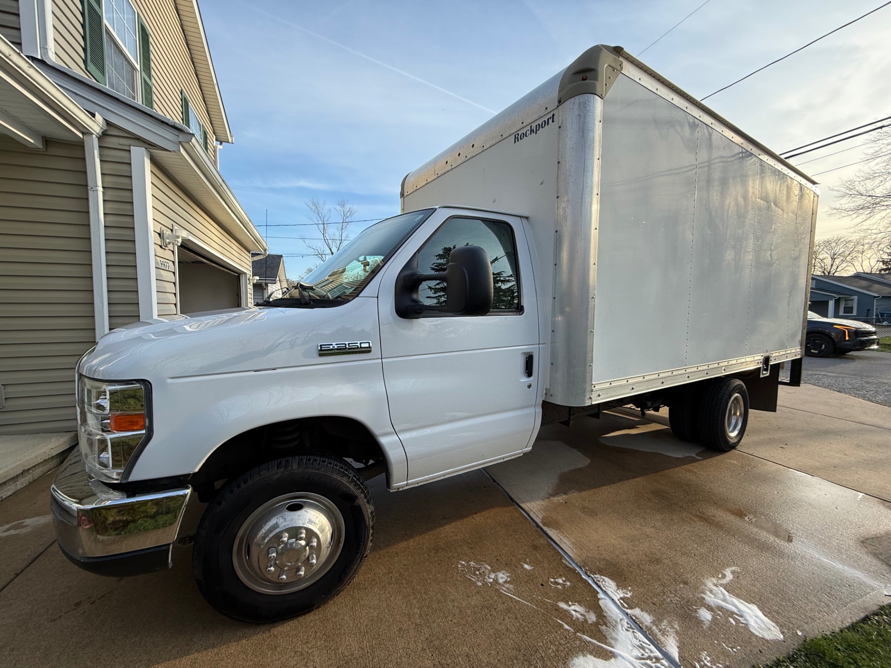 TheBestJunk Ford E-350 Rockport box truck — the junk removal truck serving Cleveland, Lakewood, Parma, Strongsville, and all of Northeast Ohio