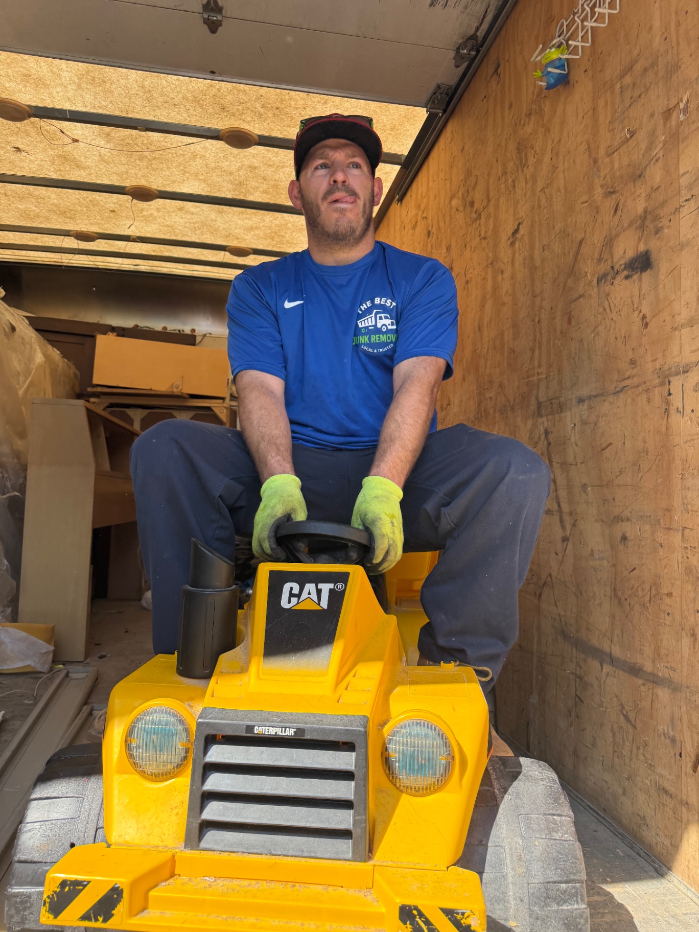 Hauling a kids ride-on toy and other furniture out of a Cleveland basement during a full-house cleanout